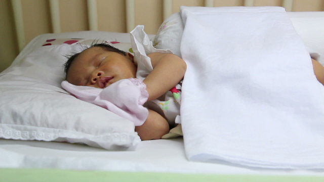 Sleeping asian baby on the wooden bed, dolly shot