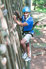 Climber in climbing wall at high rope course