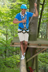 Sportsman is climbing at high rope course