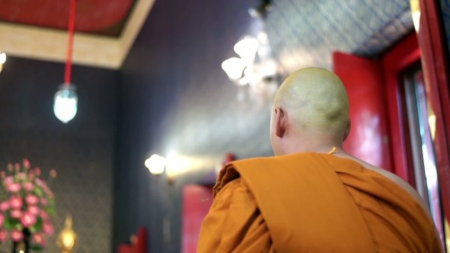 Unidentified monk praying in thai temple