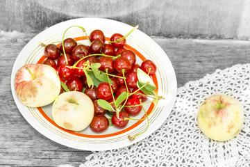 Cherry with leaves and ripe apples