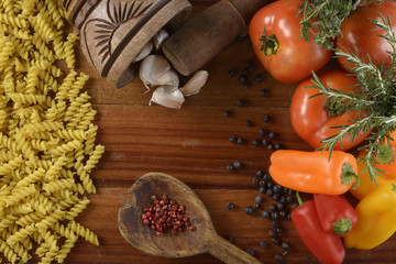 Cooking pasta with tomatoes, peppers and herbs