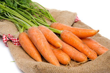 Fresh carrots on a burlap bag