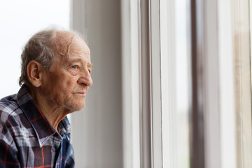Portrait of Elderly man looking out window - 68385781
