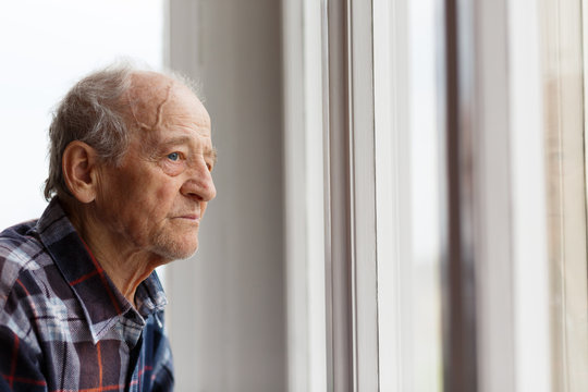 Portrait Of Elderly Man Looking Out Window