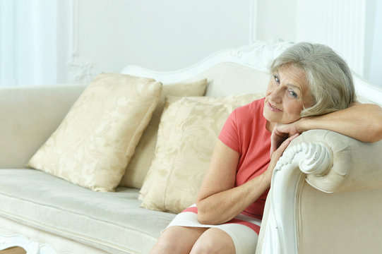 Pmature woman sitting in vintage sofa