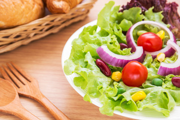Vegetables salad on plate and bread