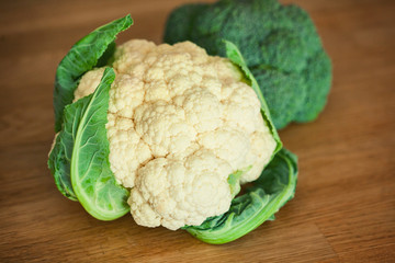 Cauliflower and broccoli on the wooden board