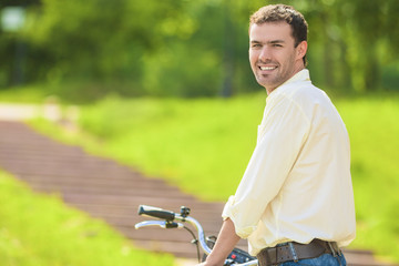 Portrait of Young Caucasian Handsome Walking with Bicycle