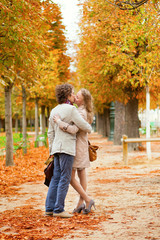 Fototapeta premium Romantic couple kissing on a beautiful fall day