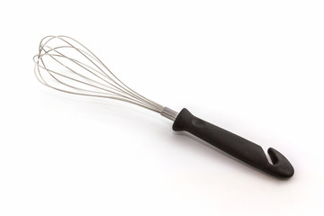 Metal whisk for whipping eggs on white background.