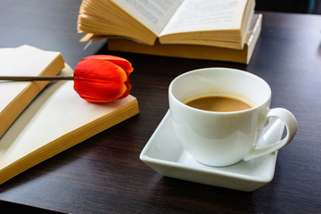 cup of coffee with tulip and book