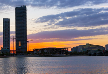Red sunset and skyscrapers near the water