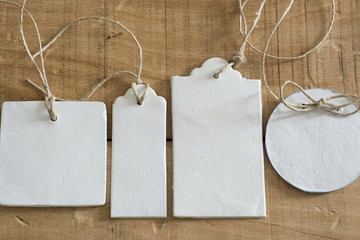 Blank tag,  round rectangular and square, on wooden background