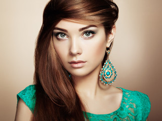 Portrait of beautiful young woman with earring. Jewelry and acce