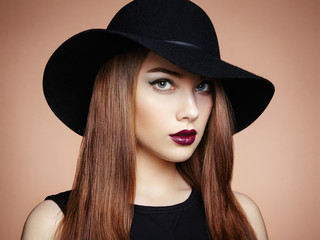 Fashion photo of young magnificent woman in hat. Girl posing