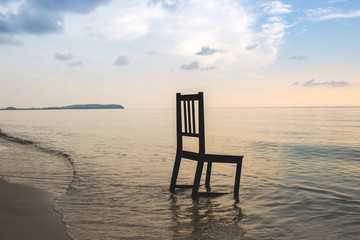 Fototapeta na wymiar Chair on the beach with sunset.