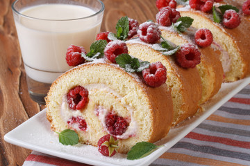 roulade with fresh raspberries closeup and milk horizontal