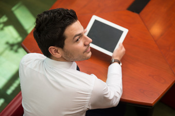 Young Man Working On Touchpad In Office