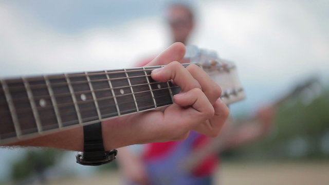 acoustic guitar fretboard hand