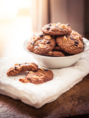 Chocolate chip cookies on napkin on wooden table.