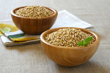 green raw buckwheat in bamboo bowl