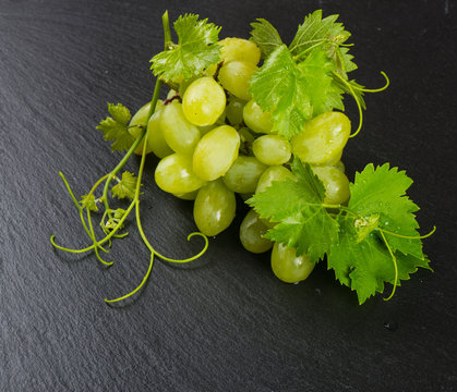 Green grape cluster on a slate  surface