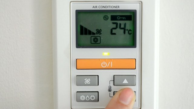digital thermostat with finger pressing button