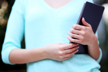 Closeup portrait of a woman holding tablet computer