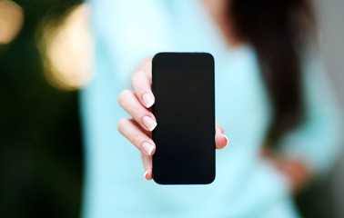 Closeup portrait of a female hand holding smartphone