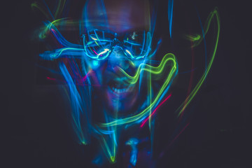 Motion, effect lightpainting man with sunglasses and colored lig