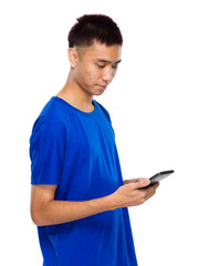 Asian young man read message on cellphone