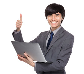 Young businessman with laptop computer and thumb up