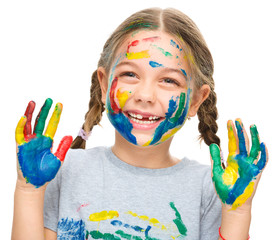 Portrait of a cute girl playing with paints