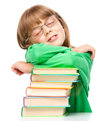 Little girl is sleeping on her books