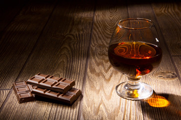 Glass of brandy with chocolate - 68415762