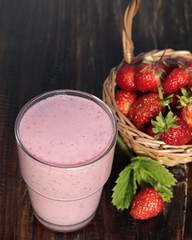 Cocktail of yogurt with strawberries and strawberry in a basket