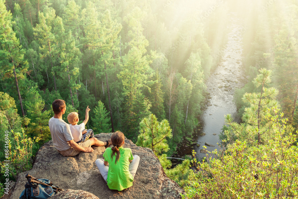 Wall mural family of backpackers look at beautiful view