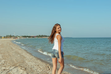 Young cheerful girl on the sea