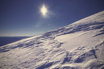 Naklejka na ściany i meble Villarica Volcano snow covered slope against the sun, Chile.