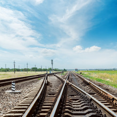 Fototapeta na wymiar crossing of railroad under cloudy sky