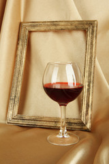 composition of frame and wine on bright background