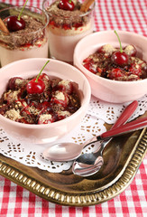 Tasty cherry dessert on table