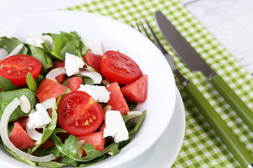 Salad with watermelon, onion, arugula and spinach leaves