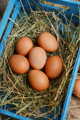 Eggs in wooden box on table close-up