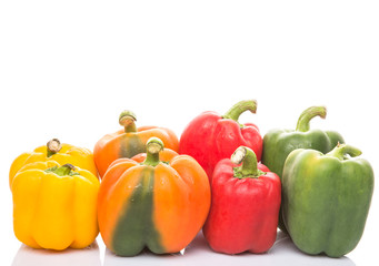 A group of different colors of capsicum over white background