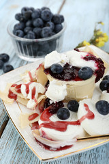 Tasty dessert with fresh blueberries on wooden table