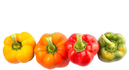 A group of different colors of capsicum over white background