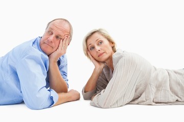 Mature couple lying and thinking