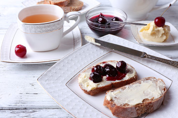 Fresh bread with cherry jam and homemade butter